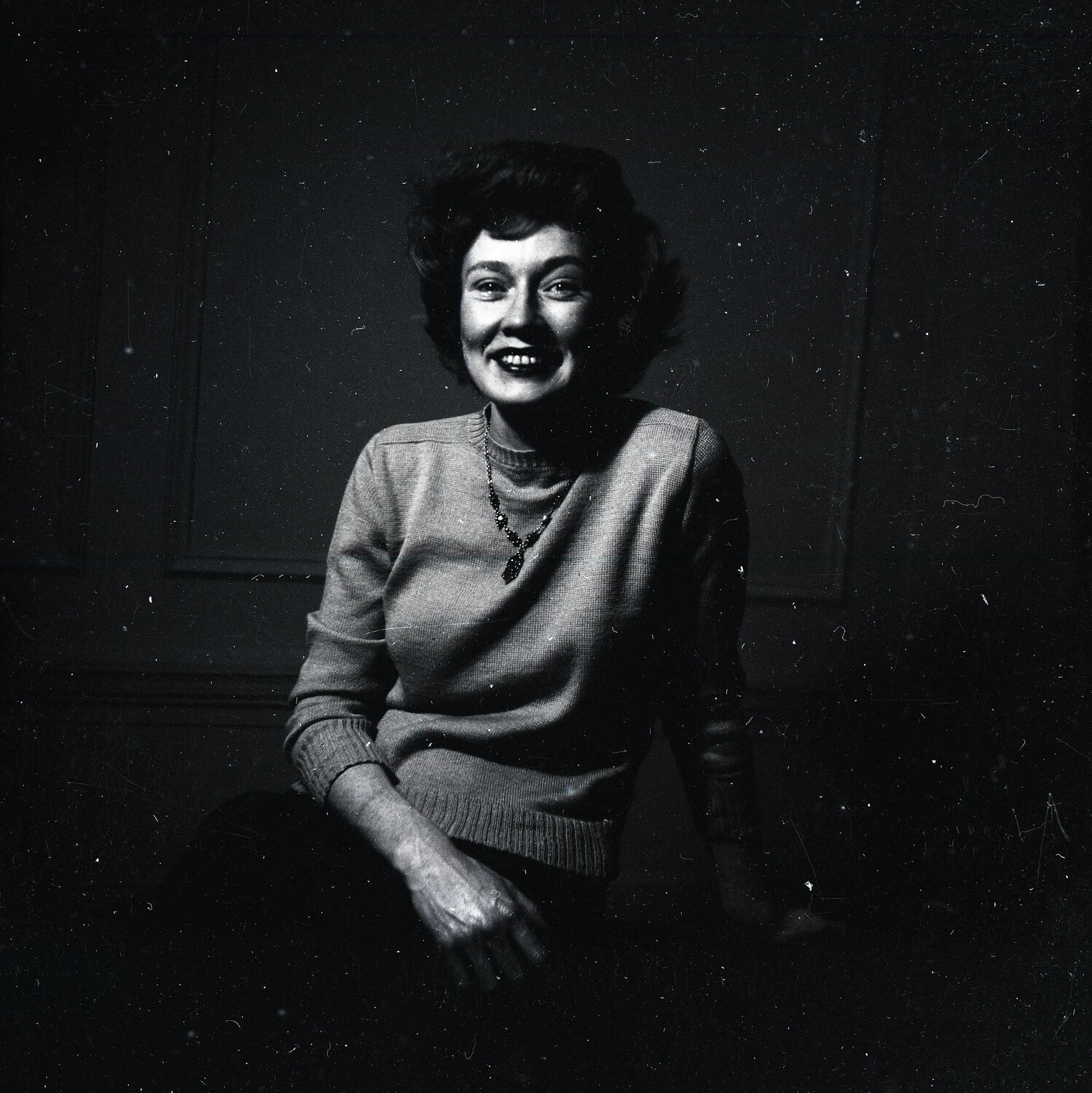 Studio Portrait of a Smiling Woman in Knit Sweater
