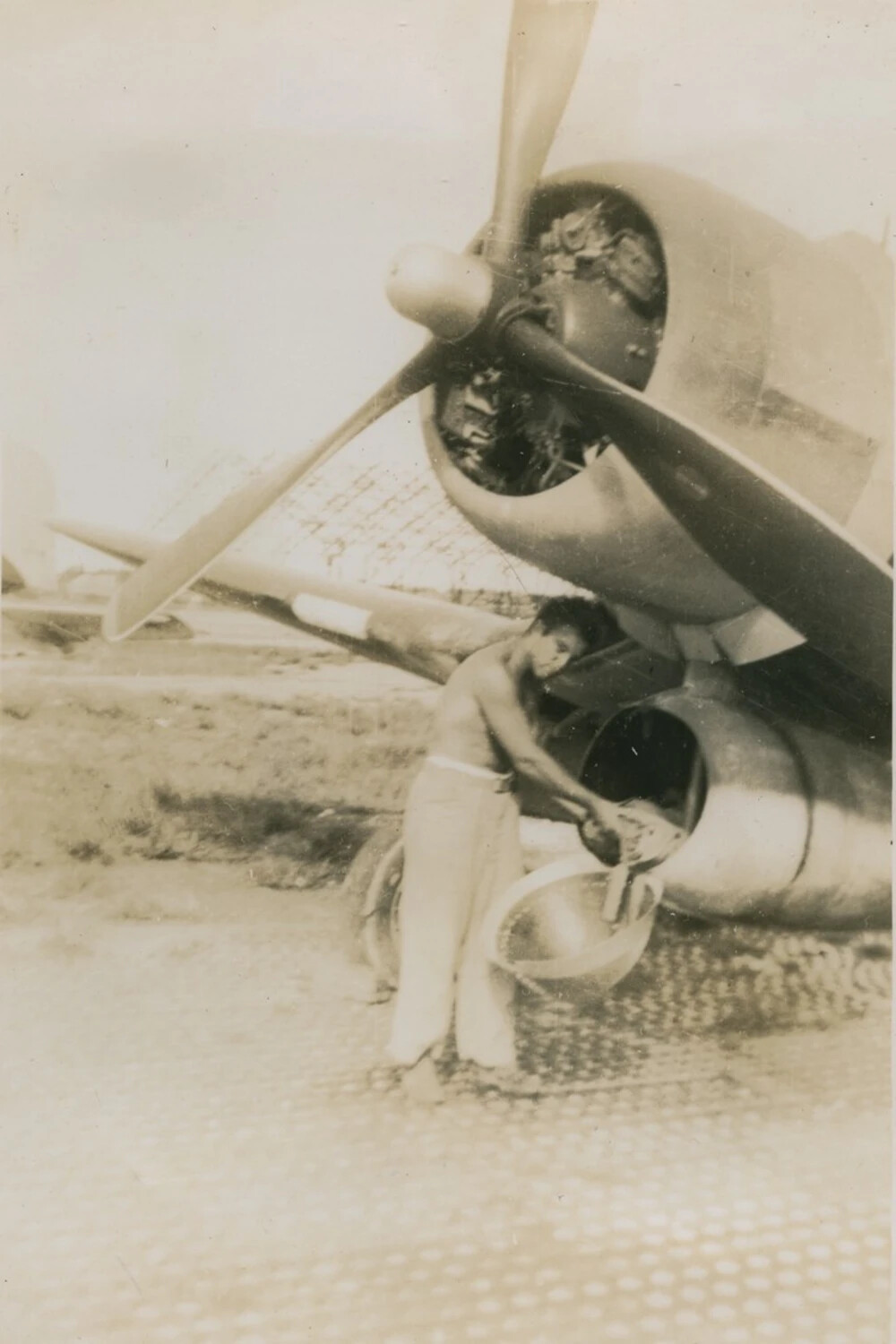 Ground Crewman Servicing Aircraft Engine on Marston Mat Airfield, McAleer Collection