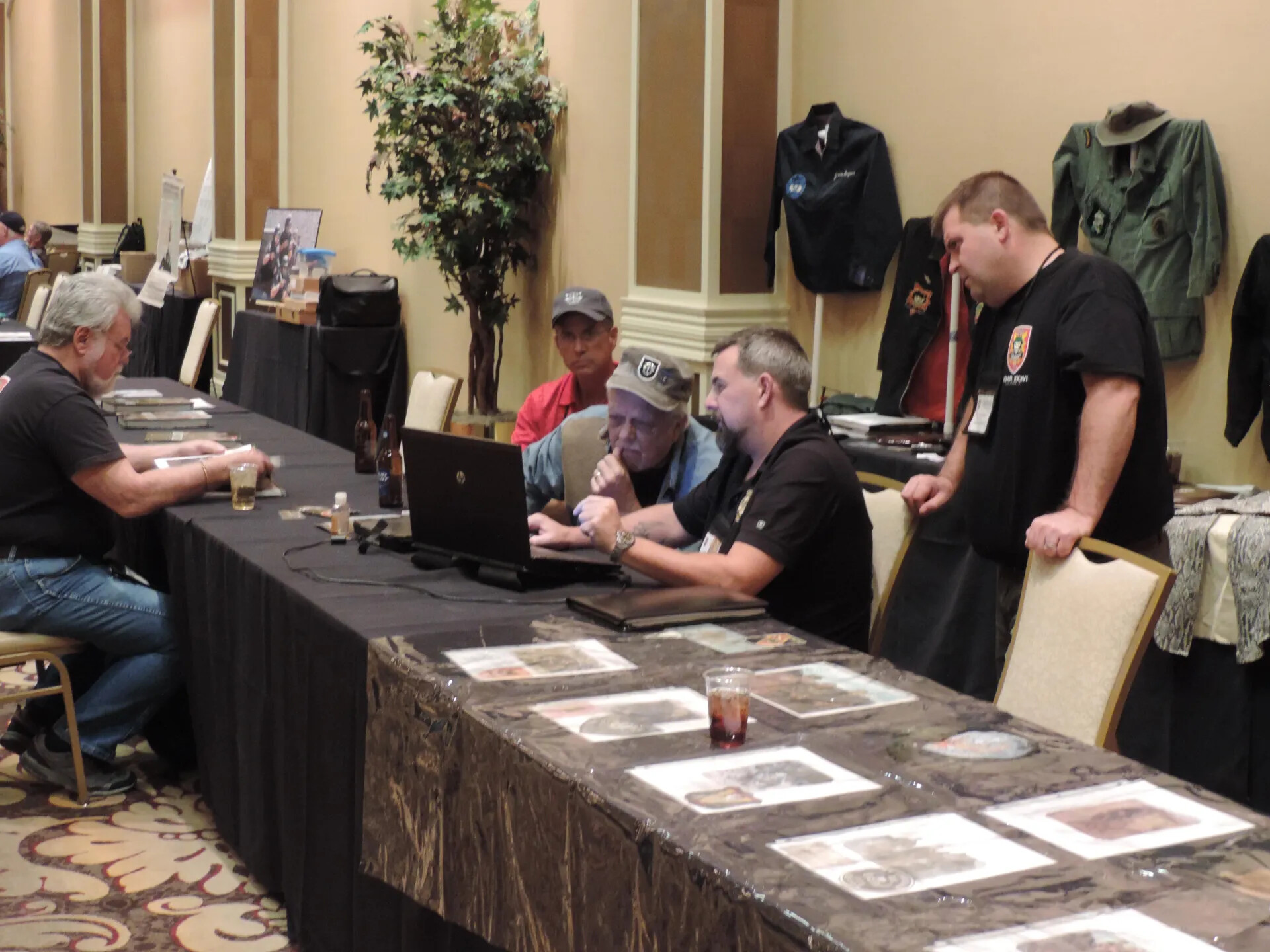 Members at Work Around a Laptop and Photographic Display, Special Operations Association Reunion, Las Vegas, 2013