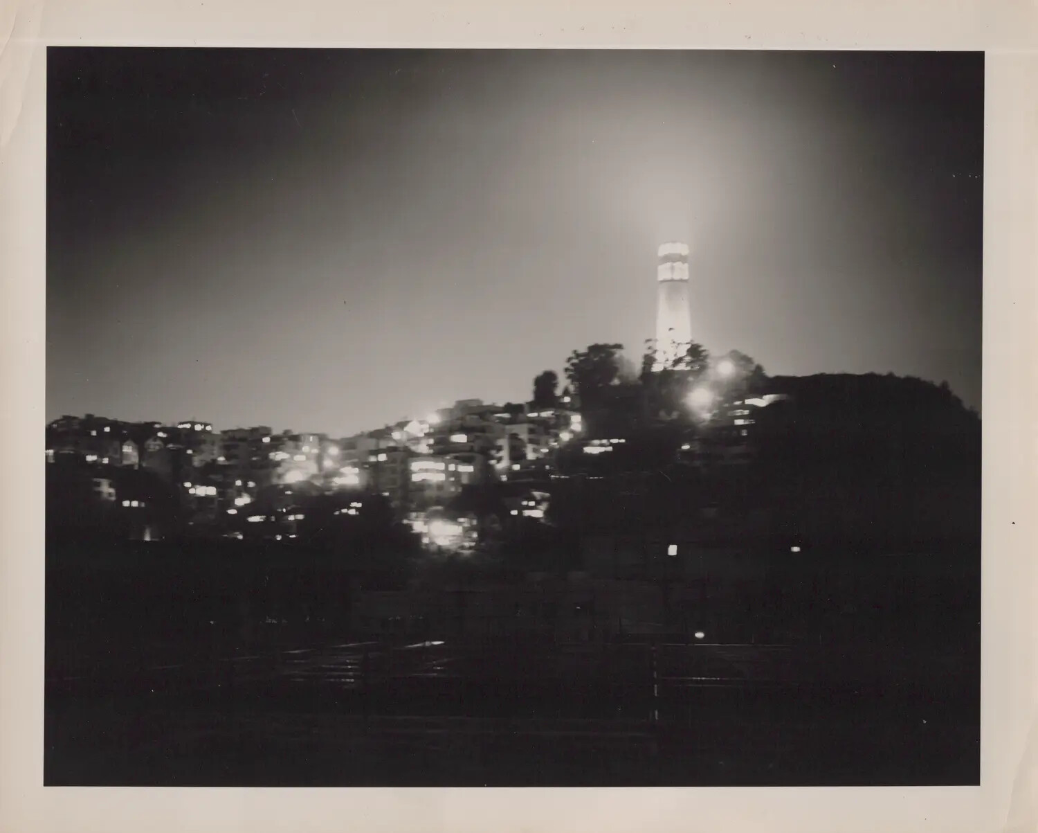 Illuminated Hilltop Tower at Night, Likely Coit Tower, San Francisco