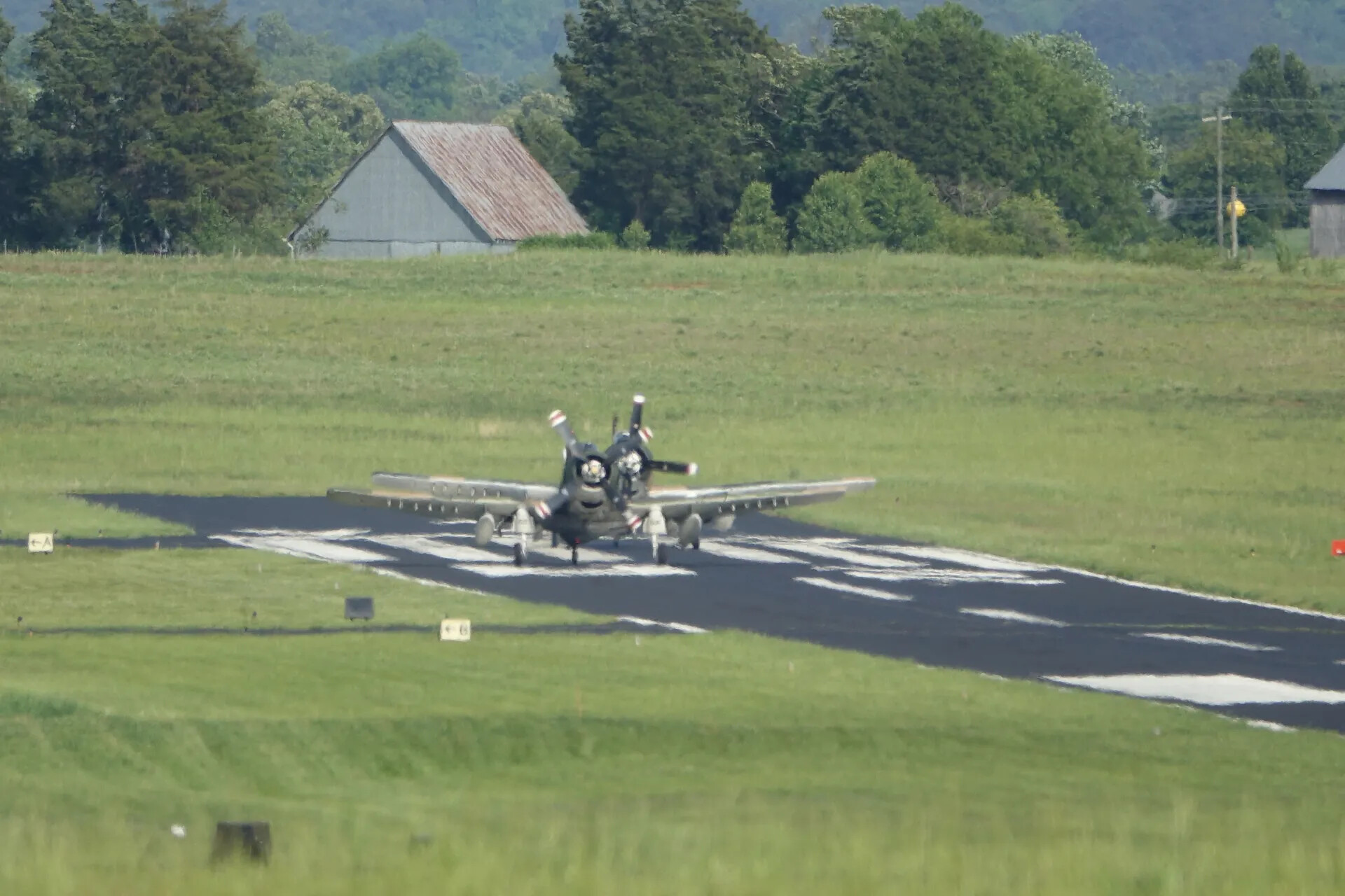 Two Douglas A-1 Skyraiders Taxiing at Rural Airfield, May 2019 Reunion Event