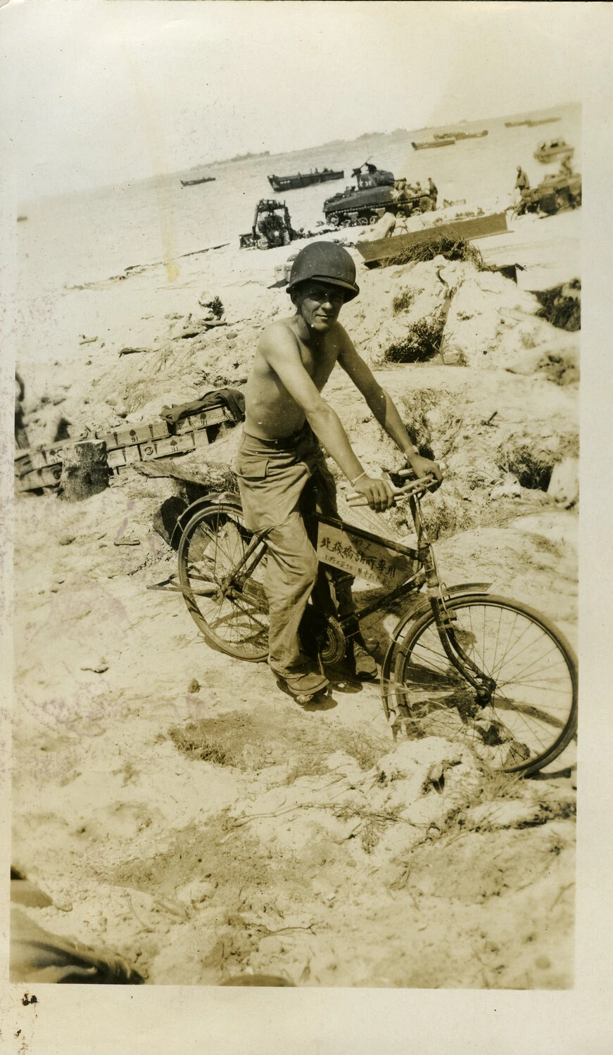 American Serviceman with Captured Japanese Bicycle on Kwajalein Beach, 1944