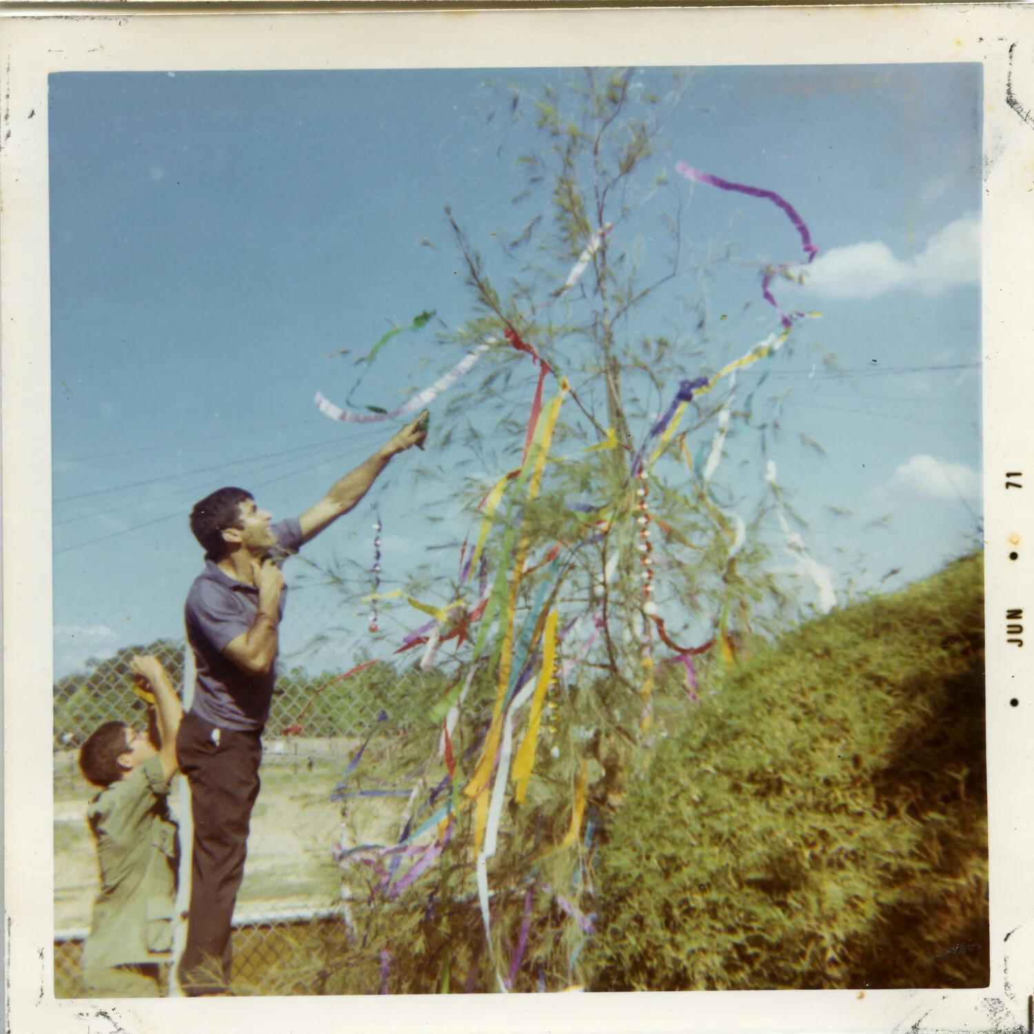 Two Men Hanging Streamers on a Decorated Tree, Vietnam Base, 1971