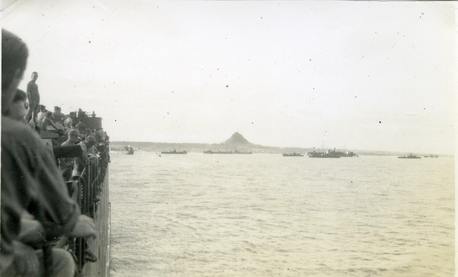 Troops Viewing Coastline and Landing Craft from Ship's Rail, Okinawa Campaign, WWII