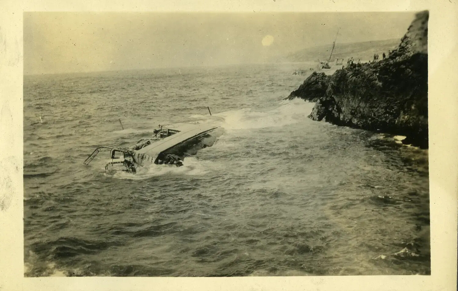 Capsized Vessel in Surf Near Rocky Coastline, USS Maryland Photo Album, 1930s