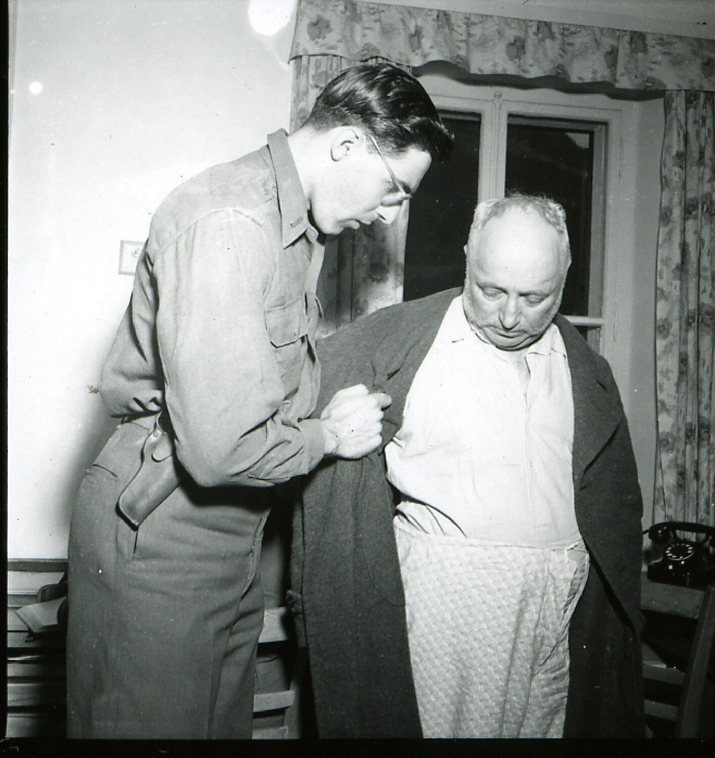 American Serviceman Assists Julius Streicher into Overcoat Following Capture, May 1945