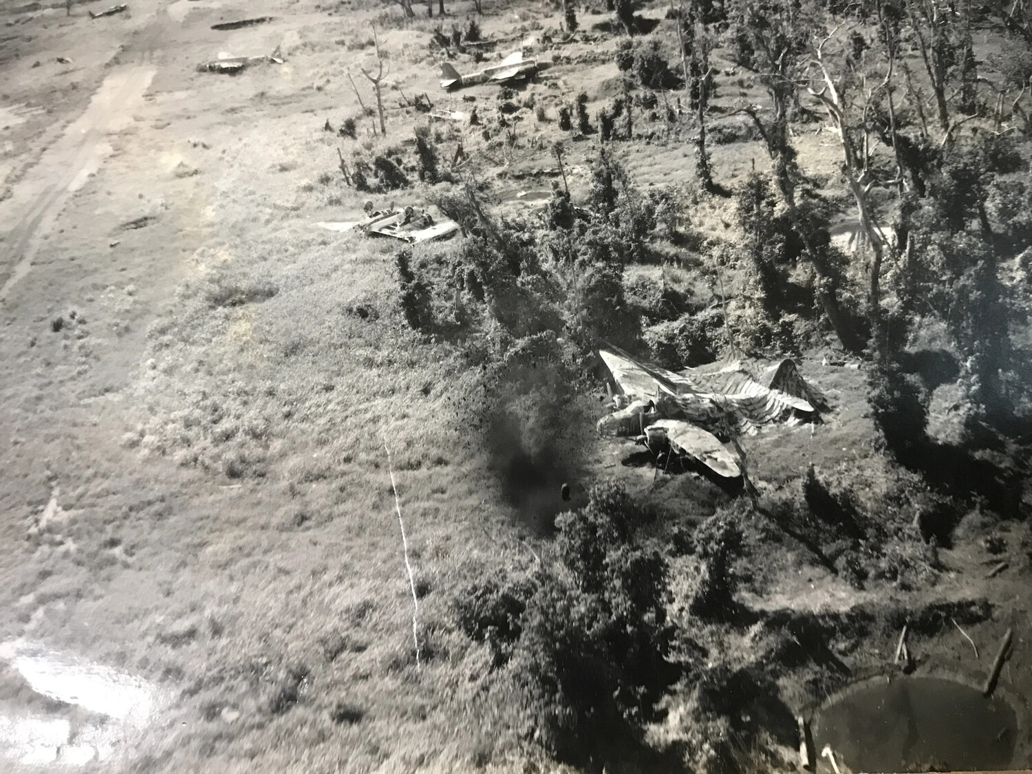 Strafing Pass Over Wrecked Japanese Aircraft in Dispersal Revetments, New Guinea