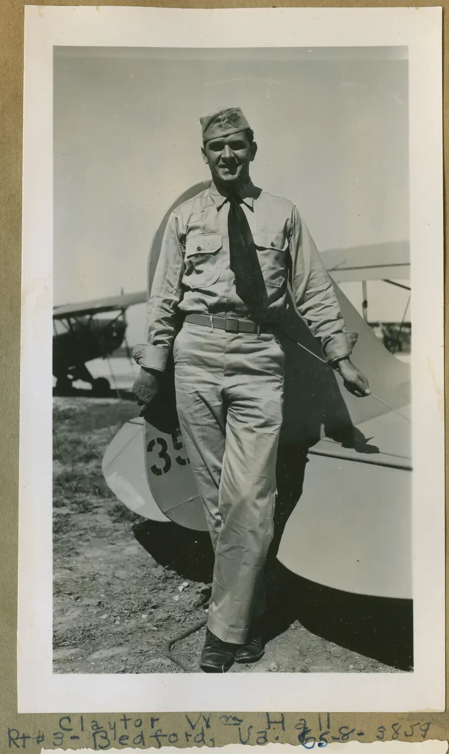 Aviation Cadet Claytor W. Hall Beside Stearman-Type Primary Trainers