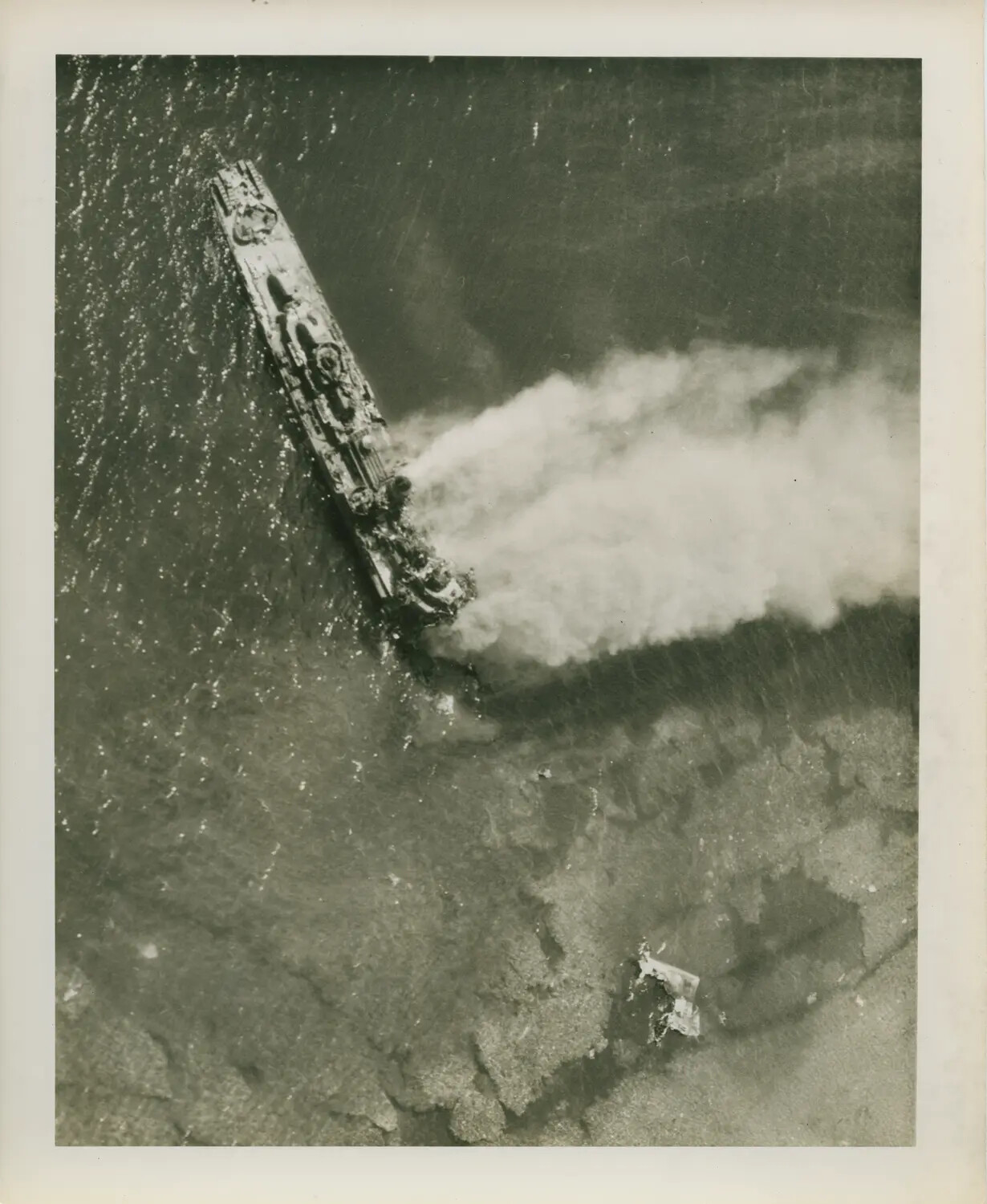 Aerial View of Warship Under Attack, Trailing Smoke and Oil Slick