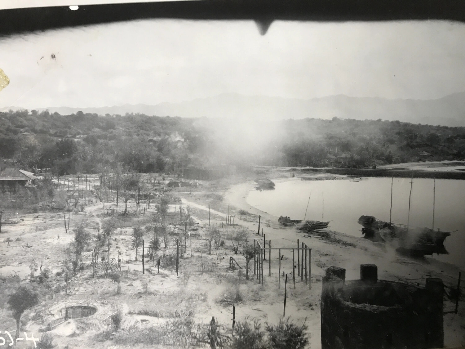 Full-Frame Post-Strike Photograph: Devastated Coastal Village with Skeletal Structures, Pacific Theater, WWII