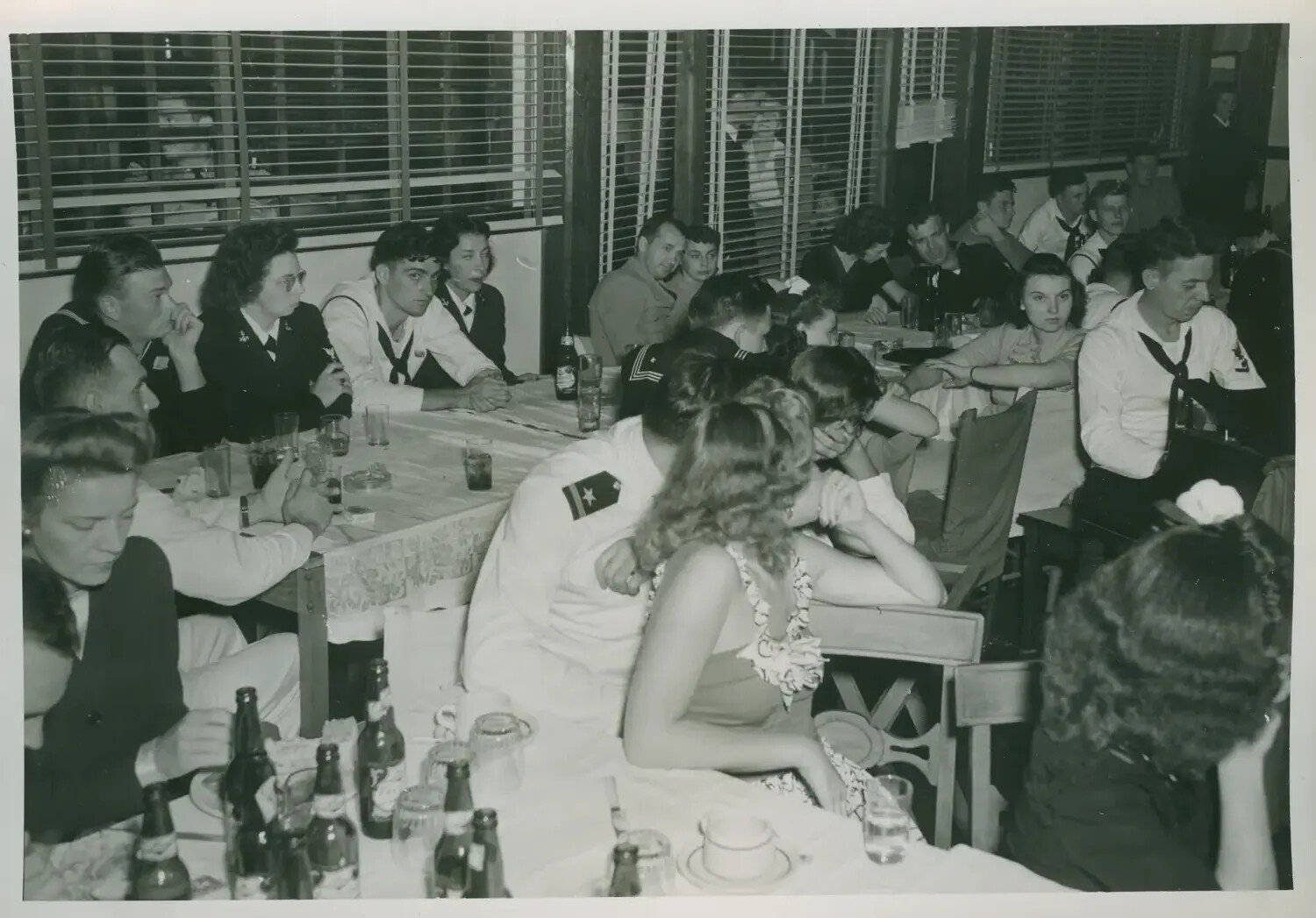U.S. Navy Sailors and Civilian Guests at an Indoor Social Gathering, USS Petrof Bay (CVE-80) Collection