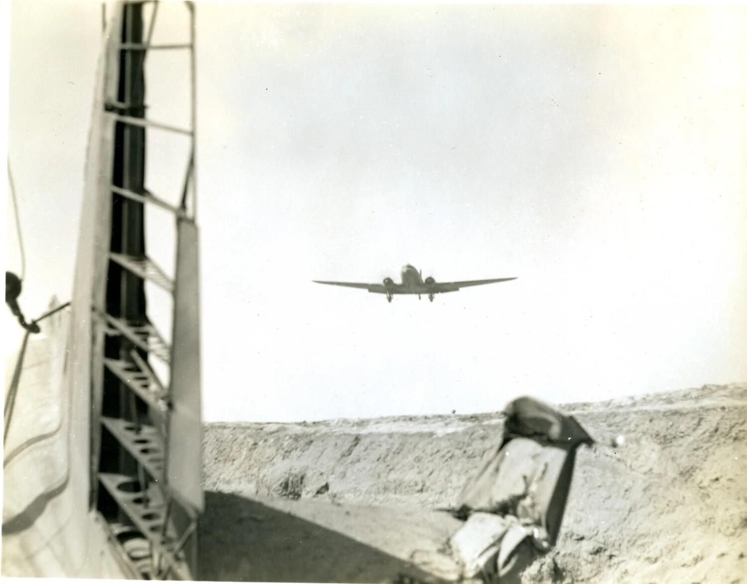 Twin-Engine Transport Aircraft on Approach, Viewed from Airfield Dugout, CBI Theater, WWII
