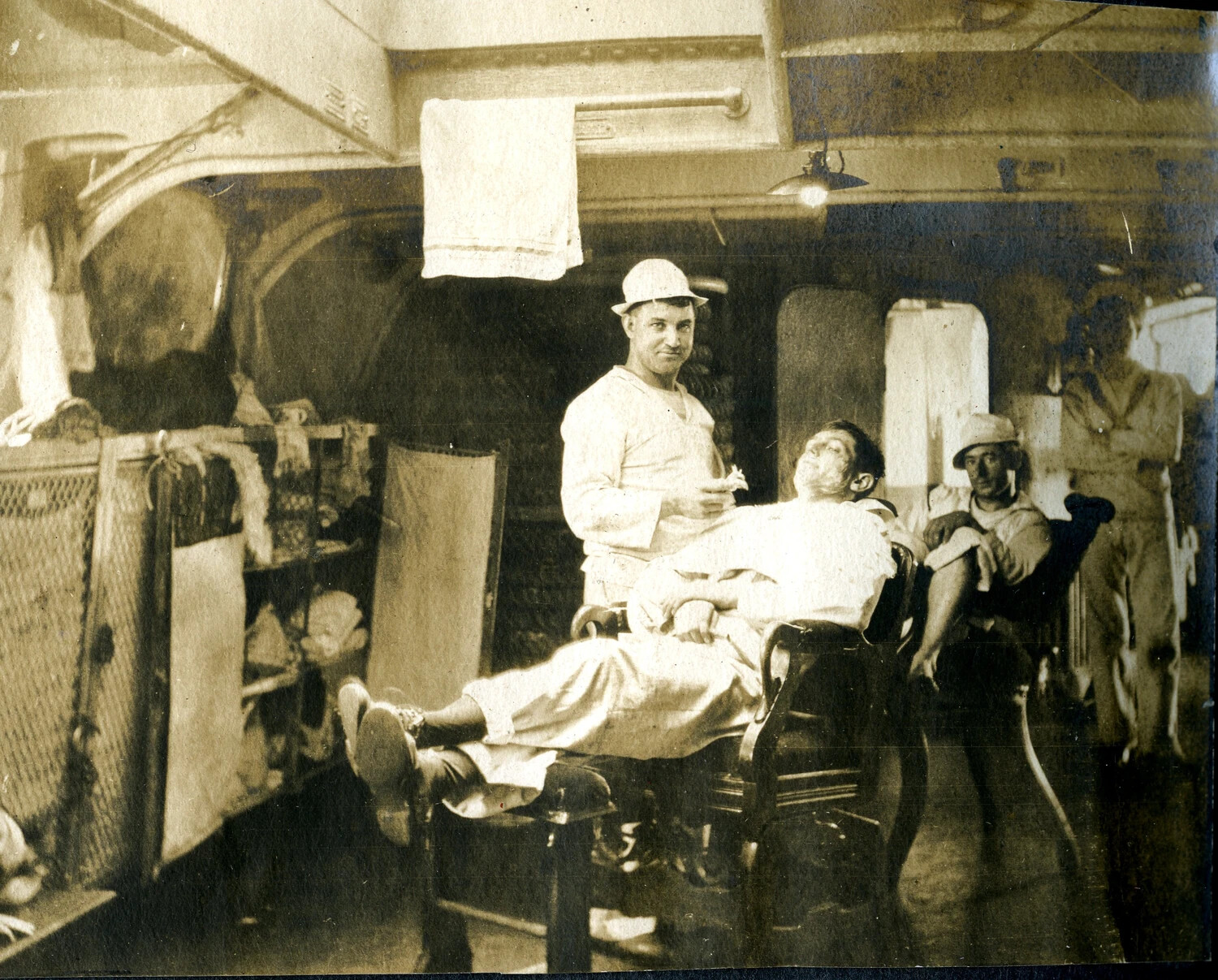 'In the Barber's Chair' -- Below-Decks Grooming Aboard USS Columbia, c. 1904-1905