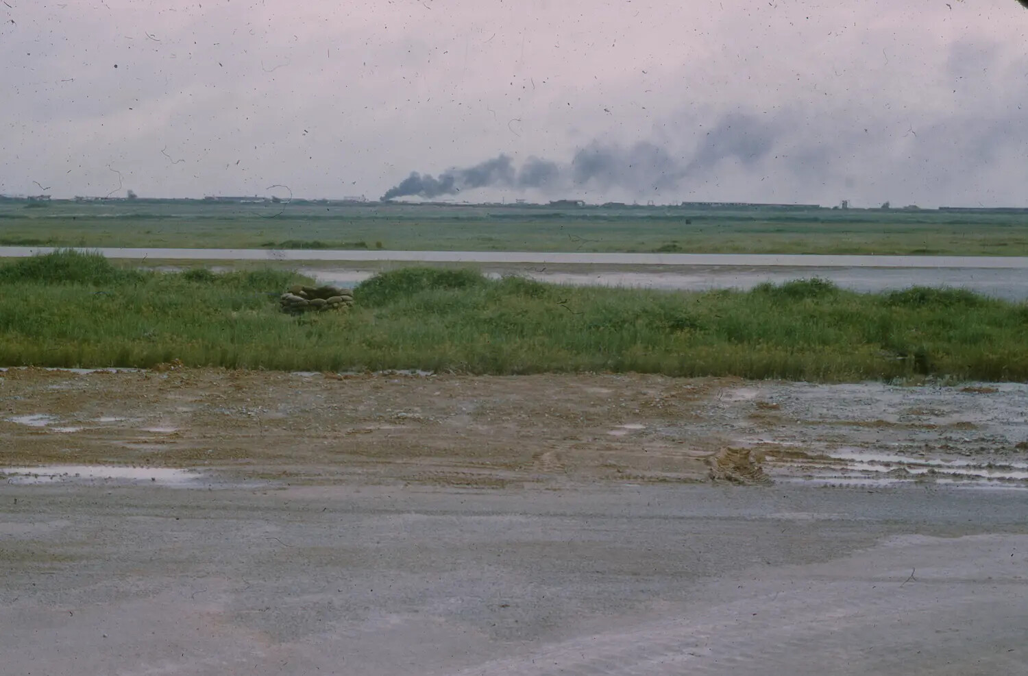 Smoke Rising Over Airfield Perimeter, South Vietnam, 1965 (3rd Tactical Fighter Wing)