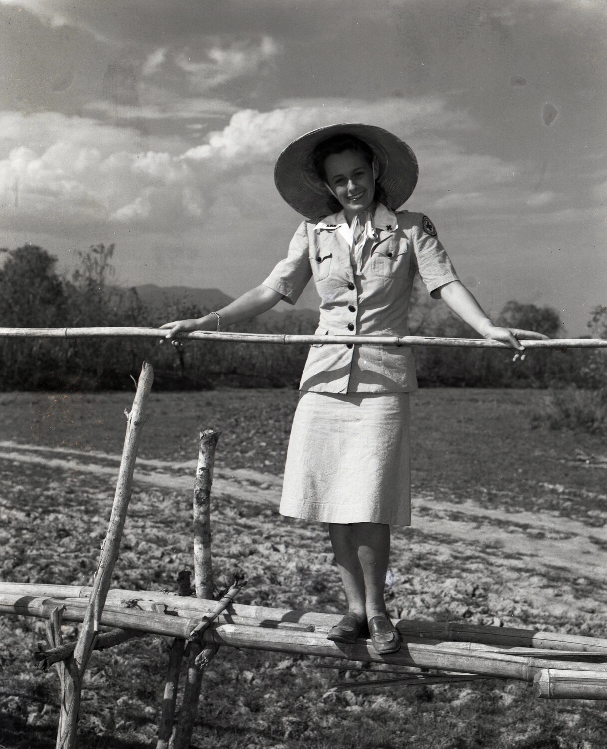 Woman in Uniform Posing on Bamboo Fence, Burma-India Theater, 1944-1945