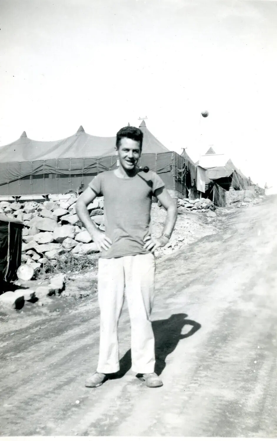 Serviceman with Pipe at Tent Camp, Pacific Theater, WWII