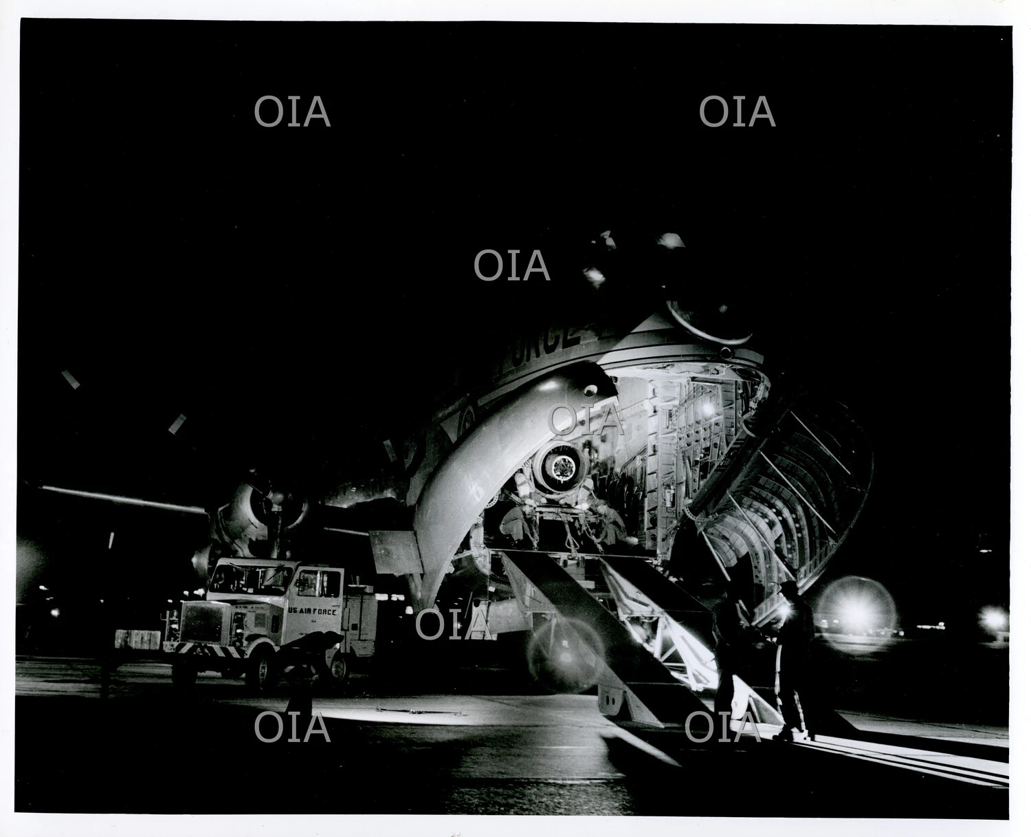 USAF Lockheed C-5 Galaxy with Nose Ramp Open During Nighttime Cargo Operations