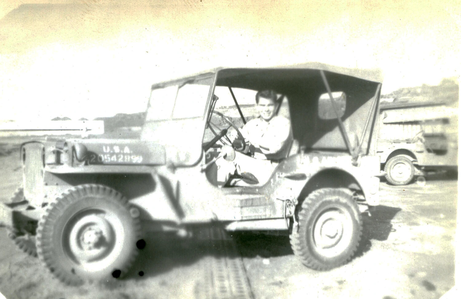 U.S. Marine Seated in Jeep with U.S.A. Registration Markings, 5th Marine Division, Iwo Jima, 1945