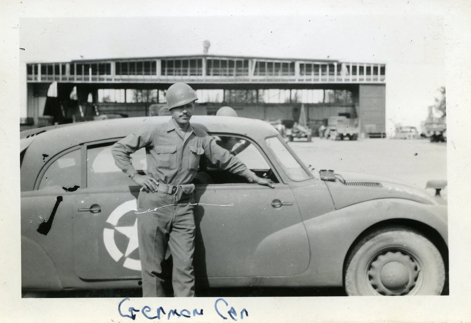 U.S. Soldier Posing with Captured German Car, 44th Infantry Division, WWII European Theater
