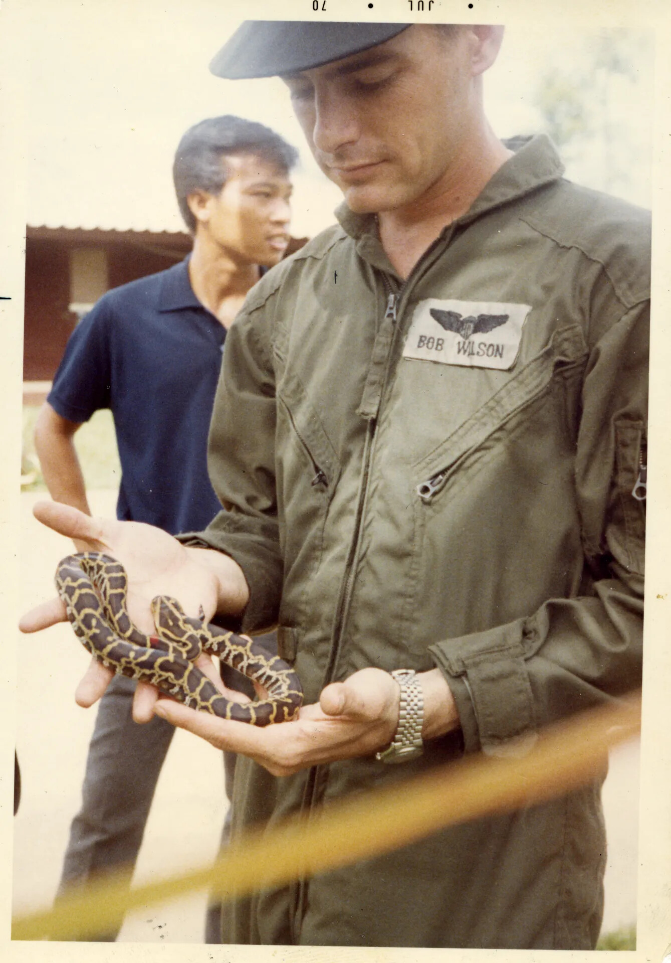 USAF Aircrewman 'Bob Wilson' Holding a Snake, NKP, July 1970