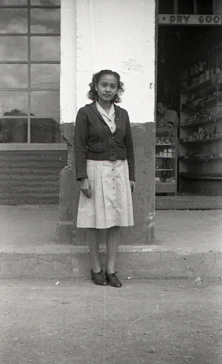 Young Woman Outside Dry Goods Store, Luzon, Philippines, WWII Era