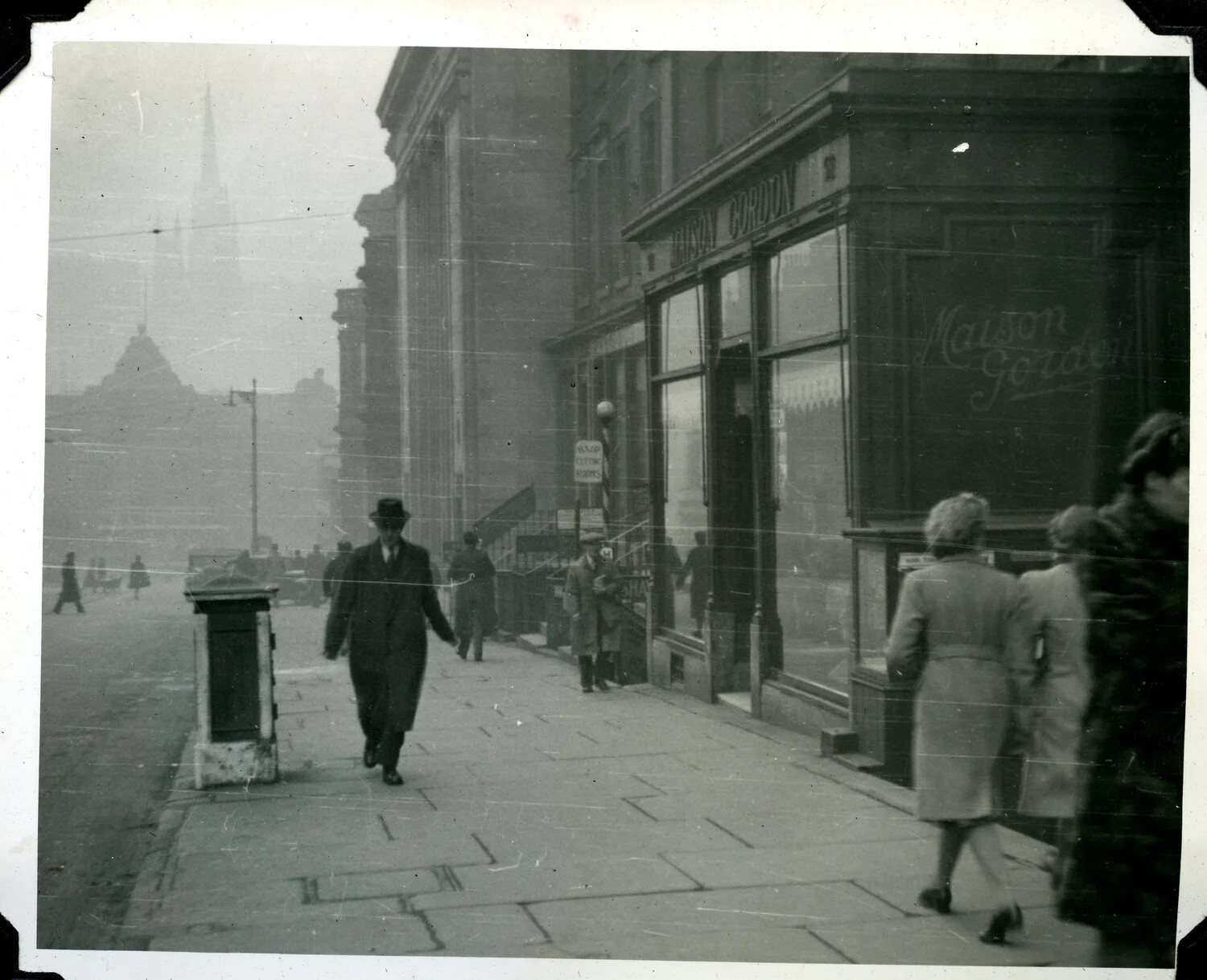 Foggy City Street Scene with 'Maison Gordon' Shopfront, WWII Era