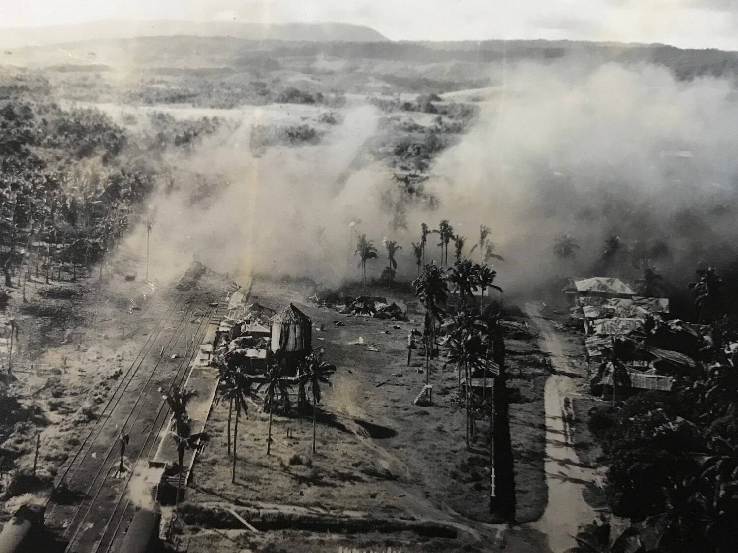 Village and Rail Line Engulfed in Smoke During Air Attack, Pacific Theater