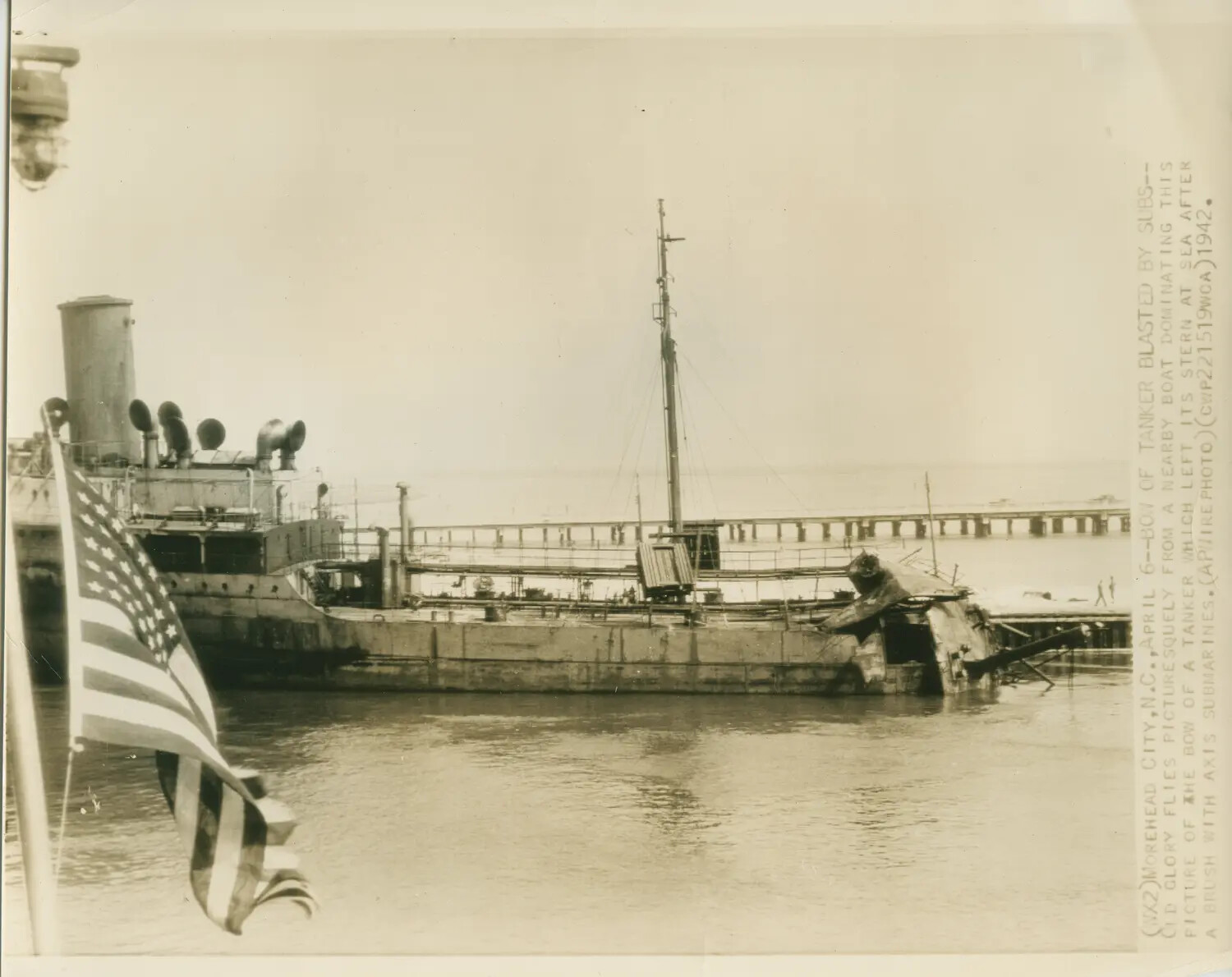 AP Wirephoto: Bow of Torpedoed Tanker with American Flag, Morehead City, N.C., April 1942