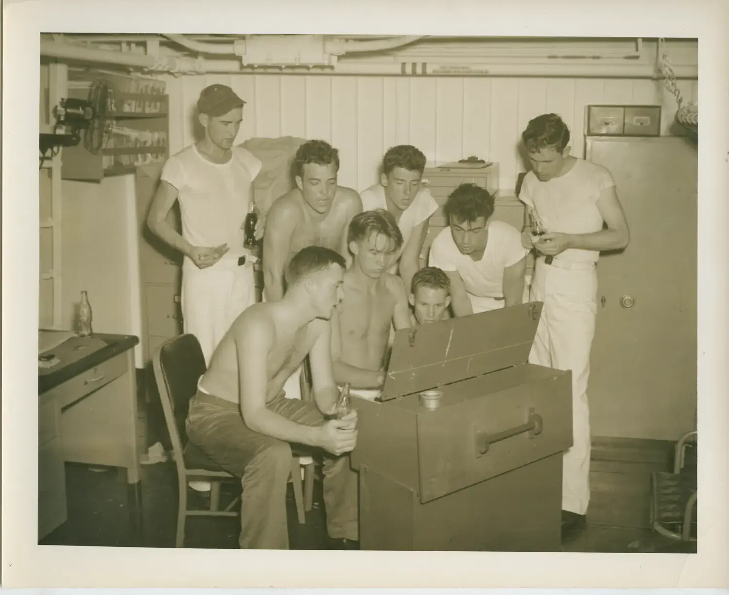 Sailors Gathered Around Cabinet Radio/Phonograph Below Decks, USS Petrof Bay (CVE-80), WWII