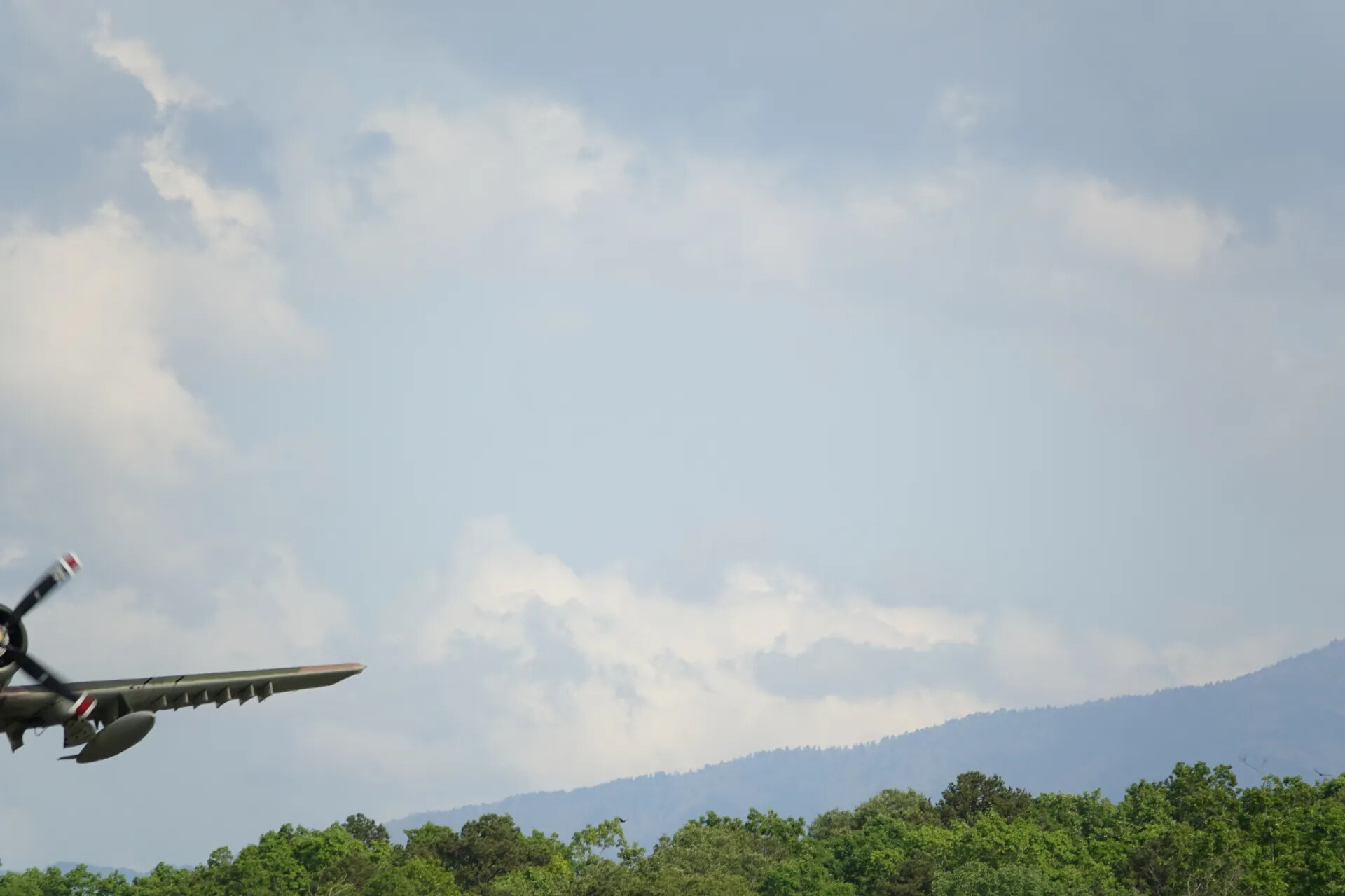 Vintage Attack Aircraft in Low Banking Flight Over Ridgeline, May 2019 Airshow