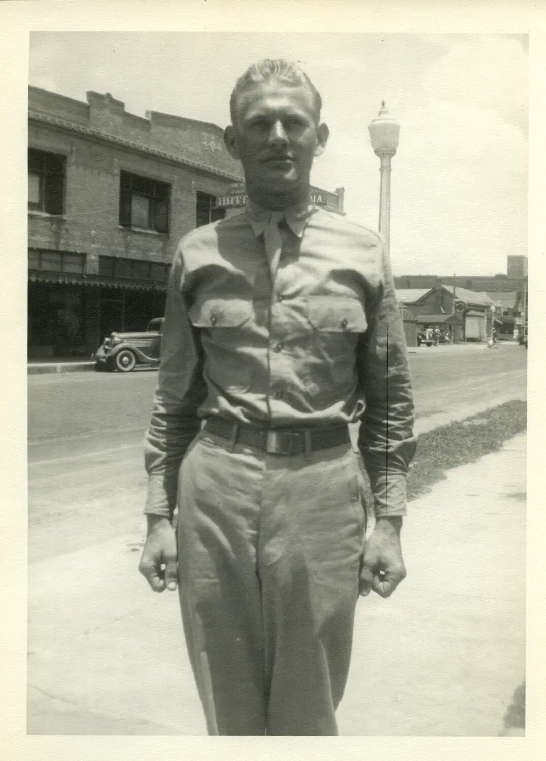 Serviceman Standing on Small-Town American Street Corner, WWII Era