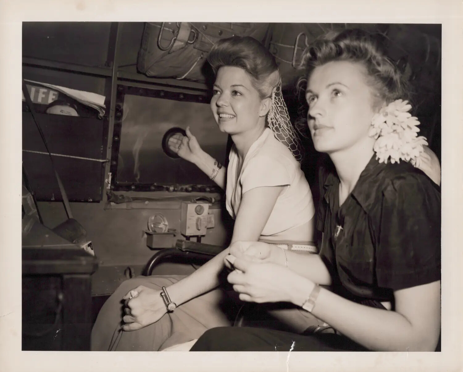 Two Young Women Aboard a WWII-Era Military Transport Aircraft