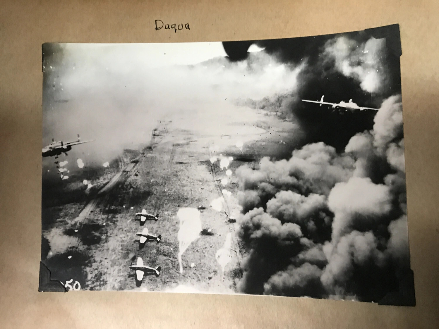 Scrapbook Page: 'Daqua' -- B-25 Mitchells Amid Smoke During Airfield Raid