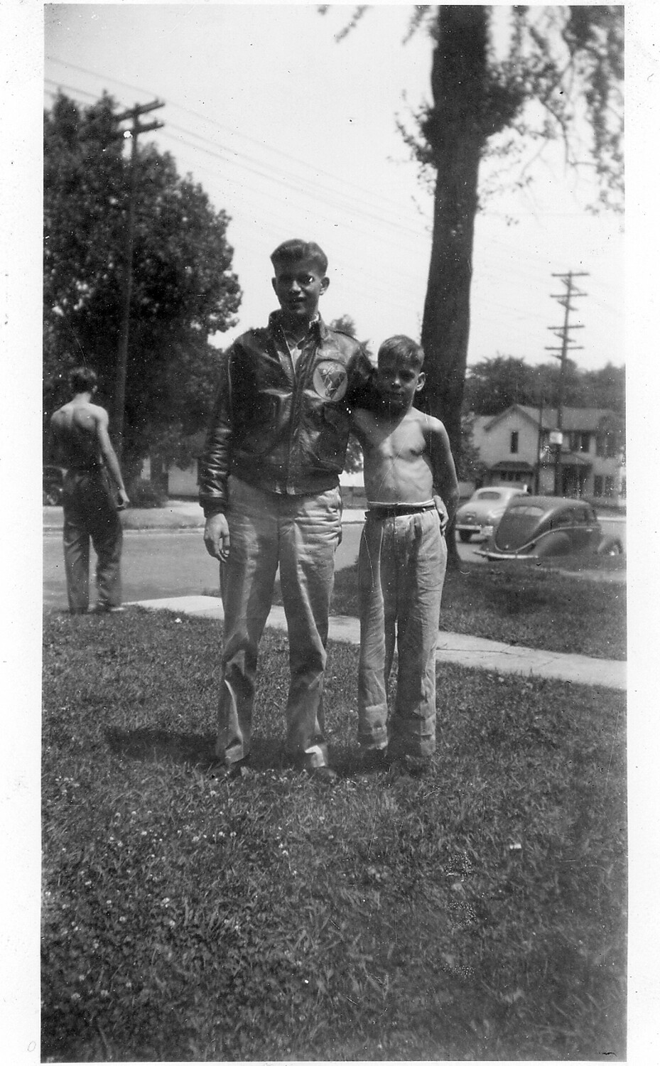 U.S. Army Air Forces Airman in A-2 Flight Jacket Posing with Younger Boy on Residential Lawn, WWII Home Front