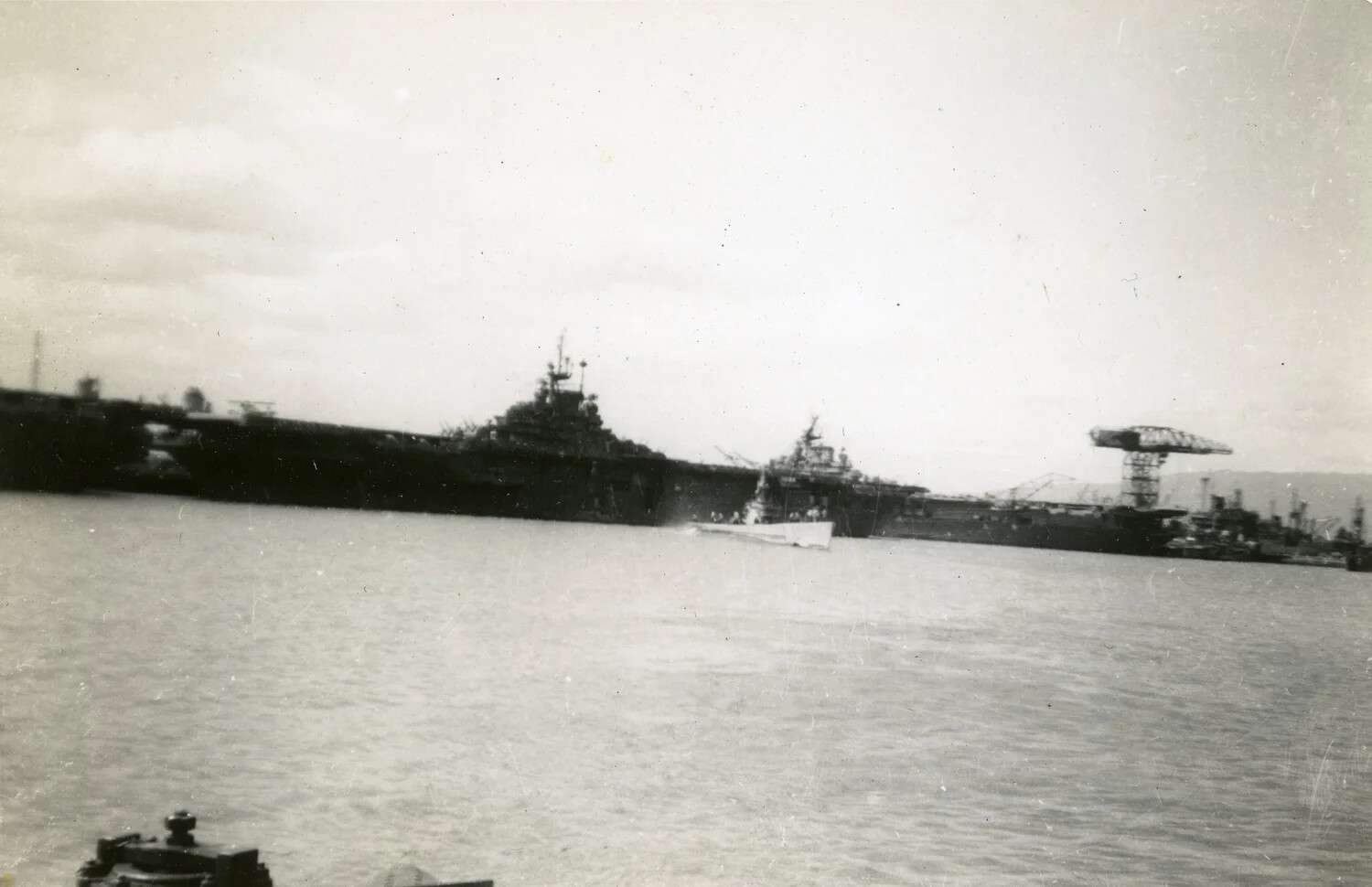 View from Submarine Deck of Fleet Carrier and Harbor Installations, Pacific Theater, WWII