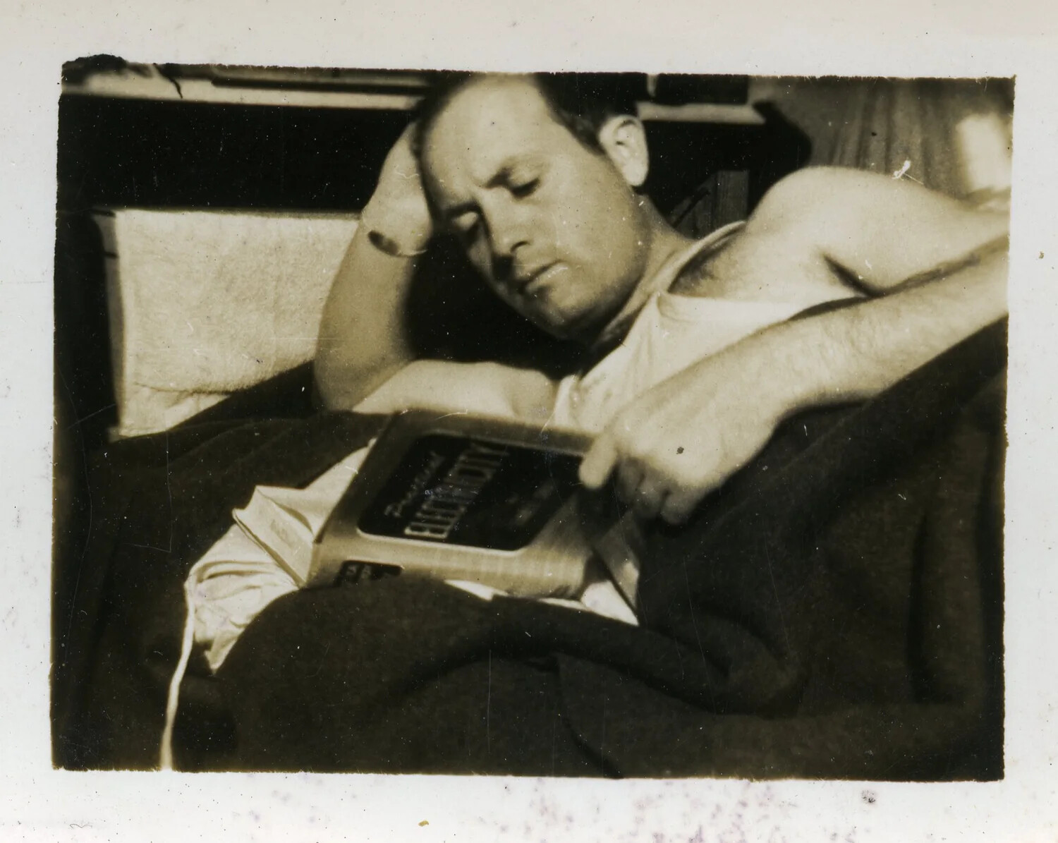Serviceman Reclining on Bunk with Book, World War II Era