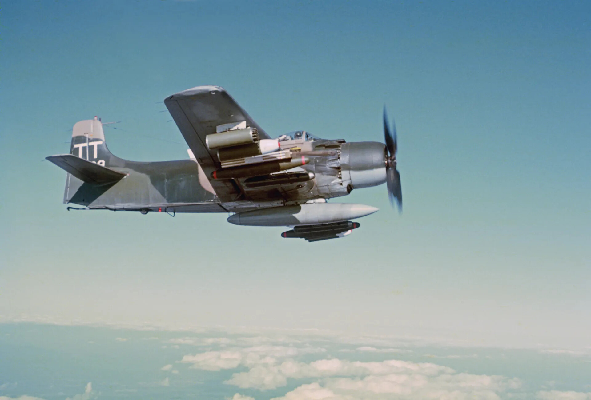 USAF A-1 Skyraider 'TT' Tail Code, Fully Armed, in Flight Over Cloud Deck