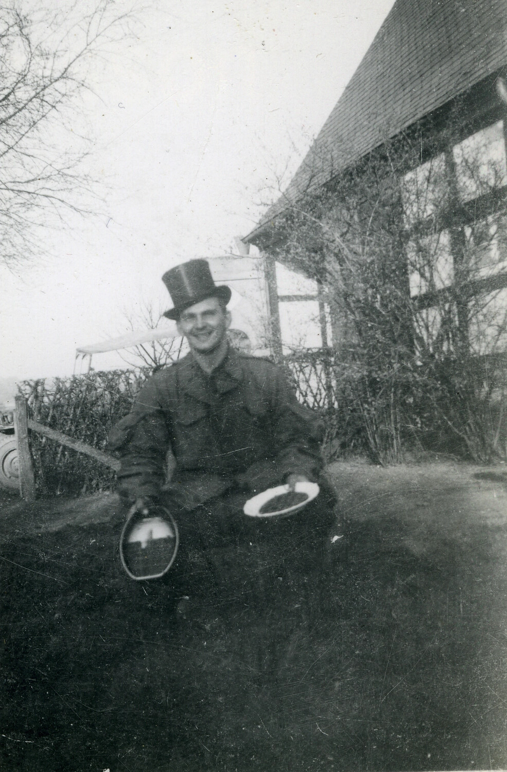 American Soldier Posing in Civilian Top Hat with Ceramic Plates, European Farmhouse