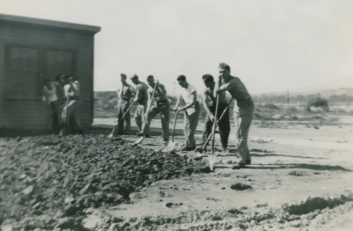 Servicemen on Work Detail Spreading Gravel, Military Base Construction