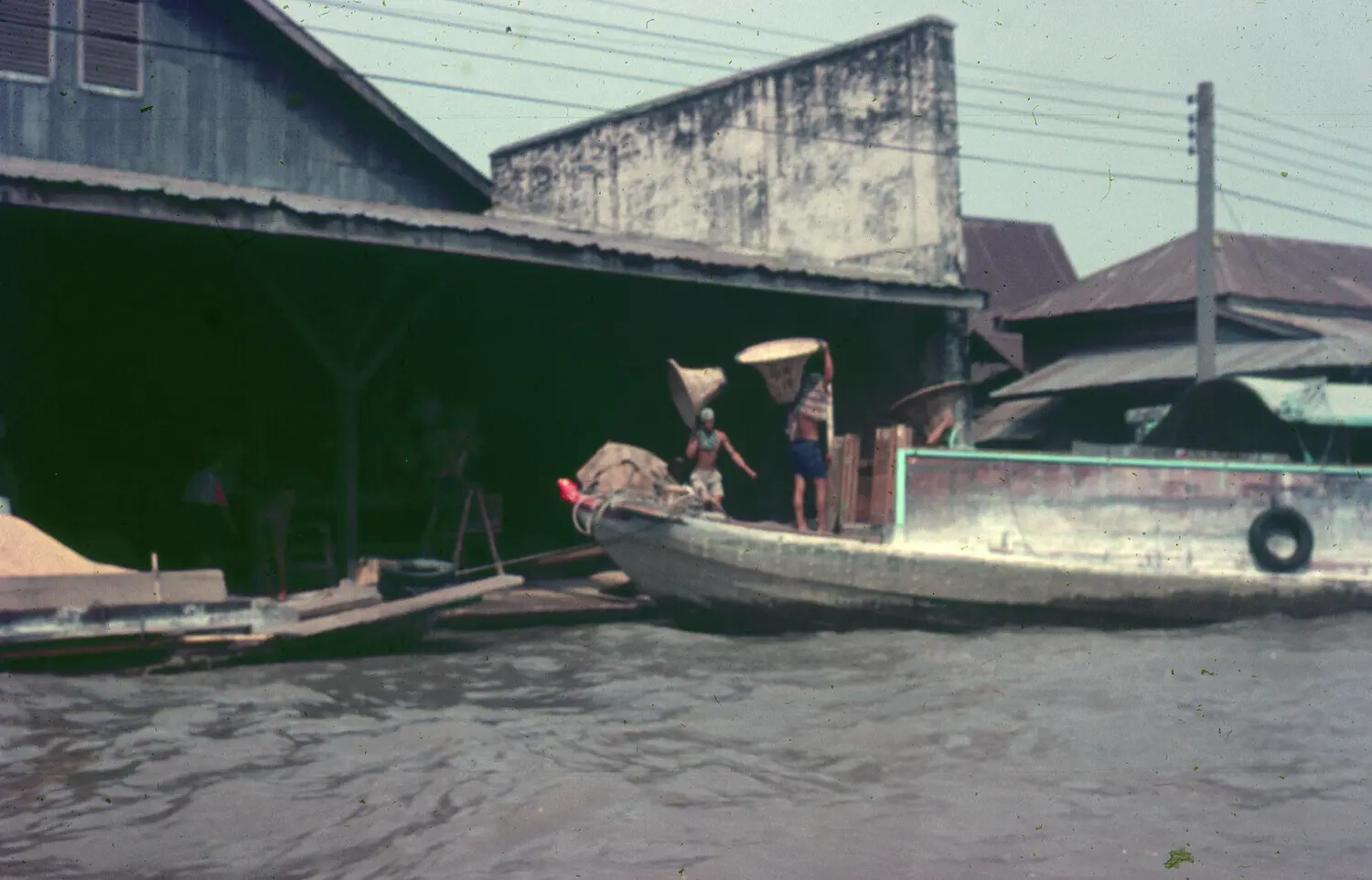 Vietnamese Riverfront Cargo Boat and Waterfront Buildings, 1965 (3rd Tactical Fighter Wing Collection)
