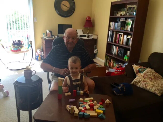 Elderly Man with a Toddler and Wooden Blocks in a Living Room, Modern Family Snapshot