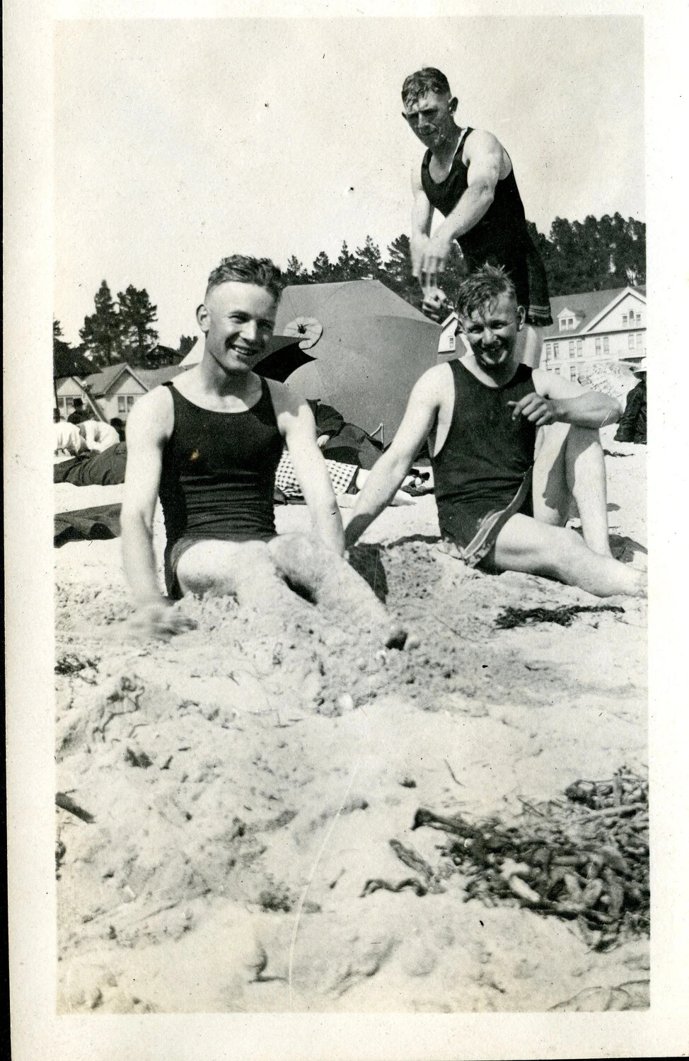 Three Young Men in Wool Bathing Suits on a Beach, Early 20th Century