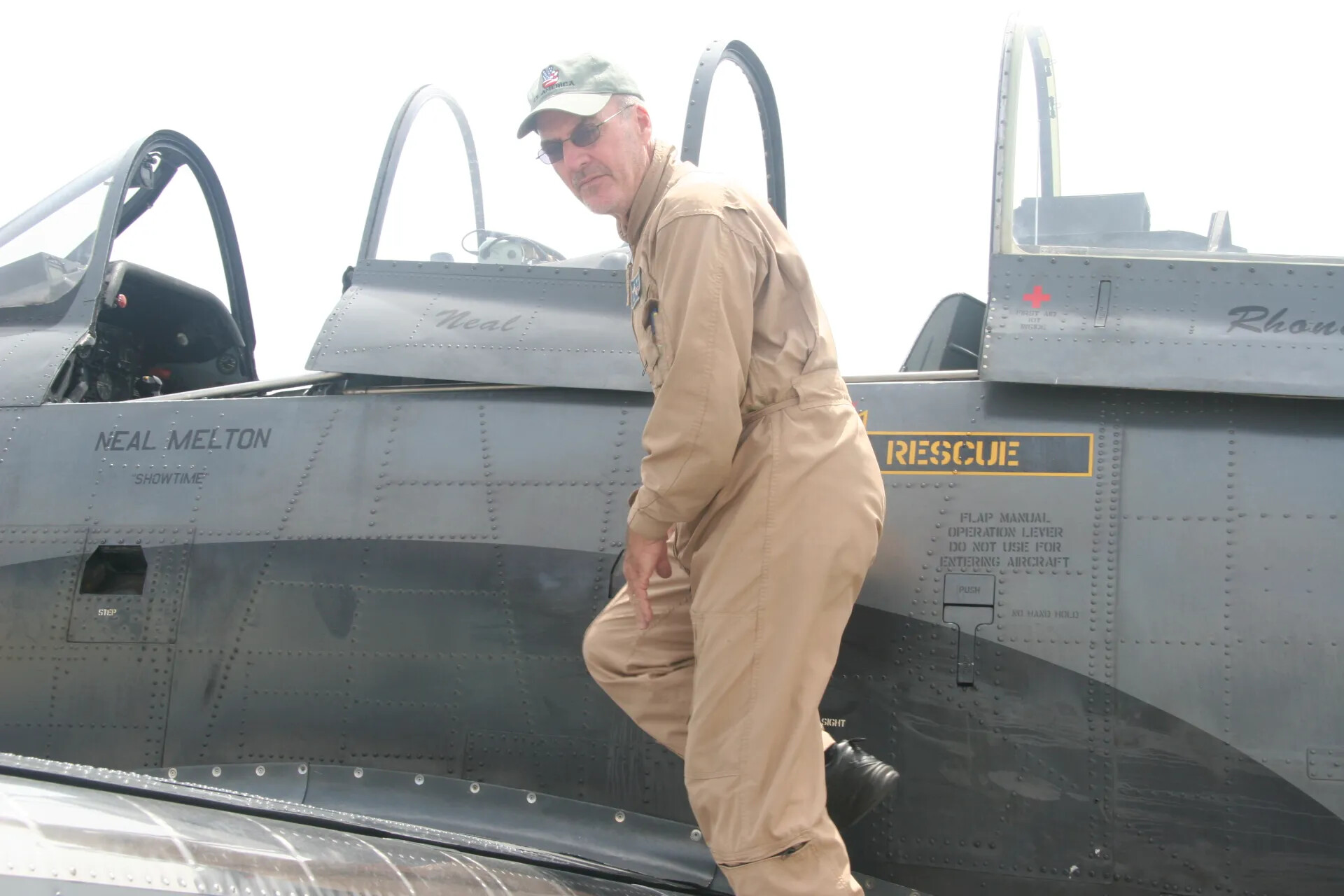 Pilot Neal Melton Boarding Restored T-28-Type Trainer Aircraft, "Showtime"