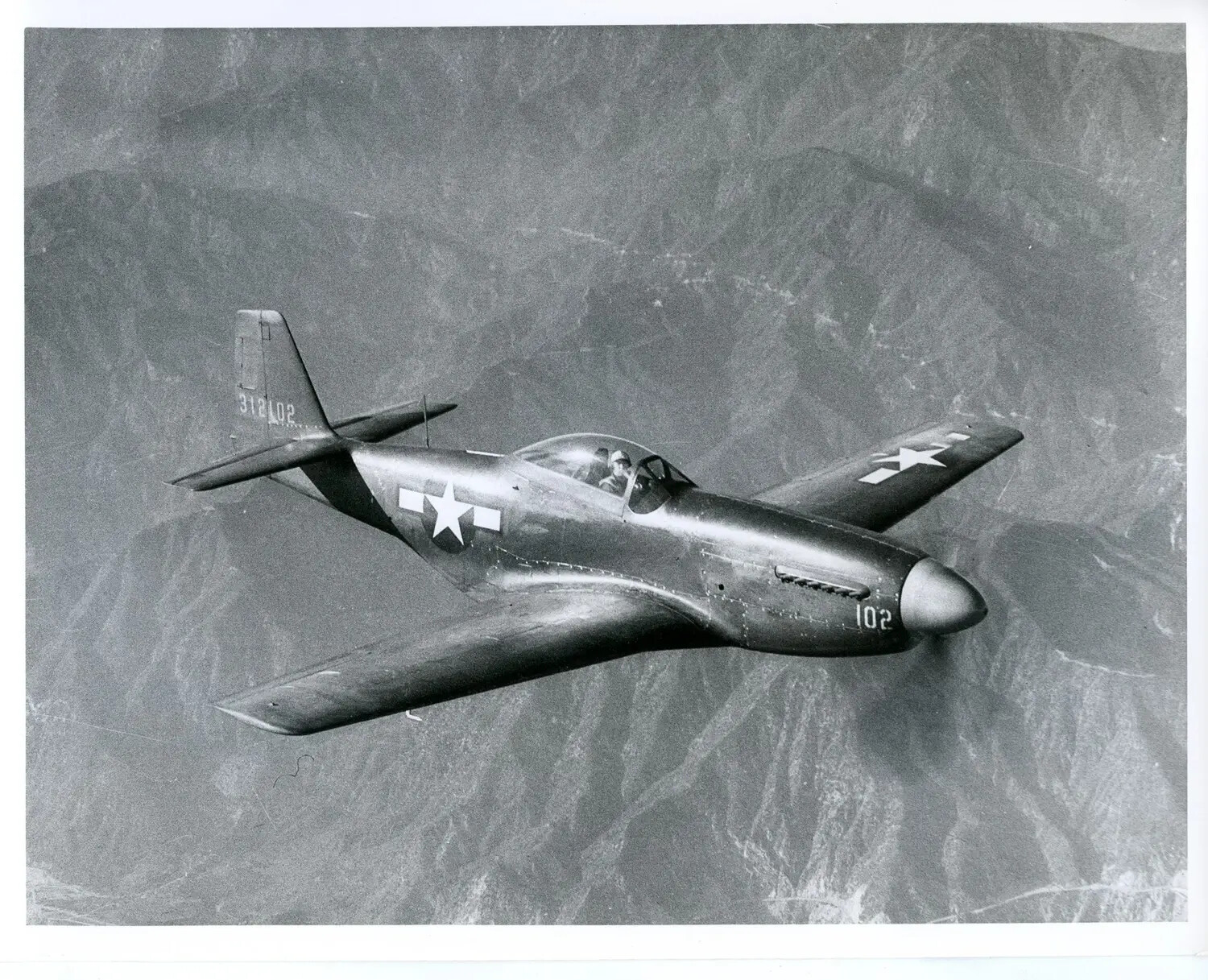 North American P-51 Mustang in Flight Over Mountainous Terrain, USAAF/USAF Official Photograph