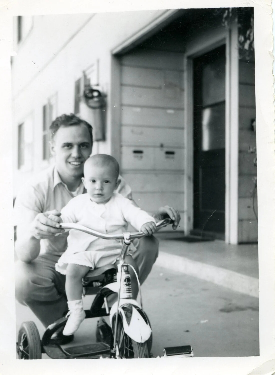 Man Assisting Child on Tricycle, Home Front Family Snapshot, c. 1950s (Bancroft Collection)