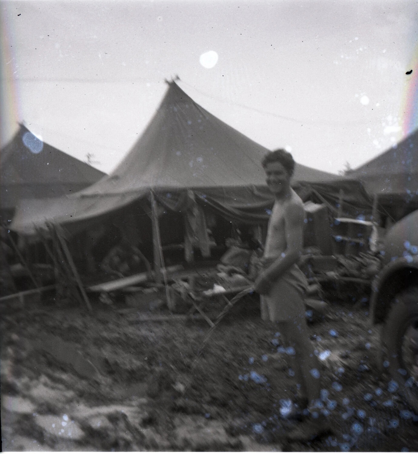 Serviceman Walking Through Tent Camp, 345th Bomb Group Encampment, Ie Shima, WWII (Damaged Negative)
