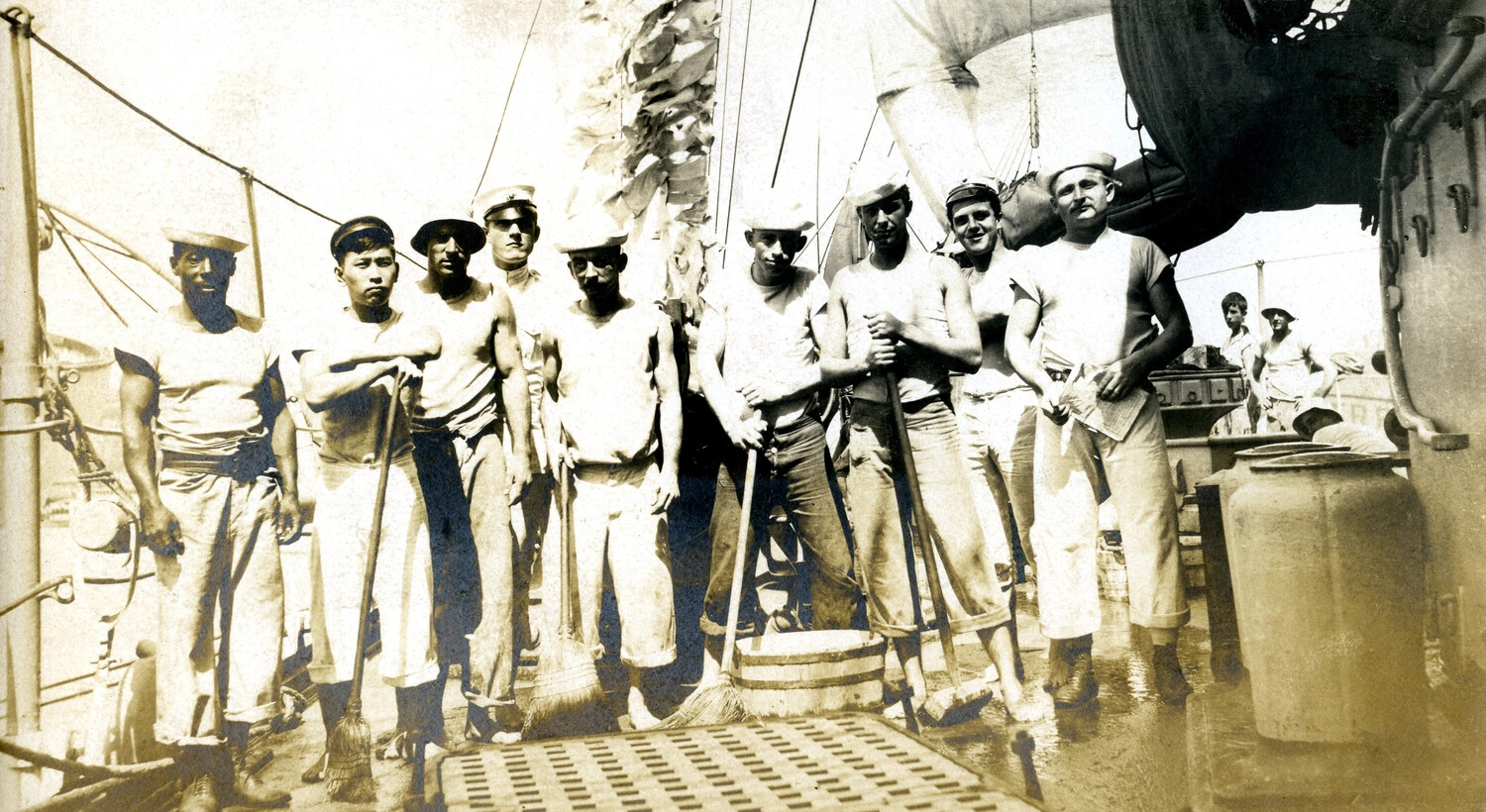 Crew Posed with Mops and Brooms, 'Scrubbing Down Decks,' USS Columbia, c. 1898-1910