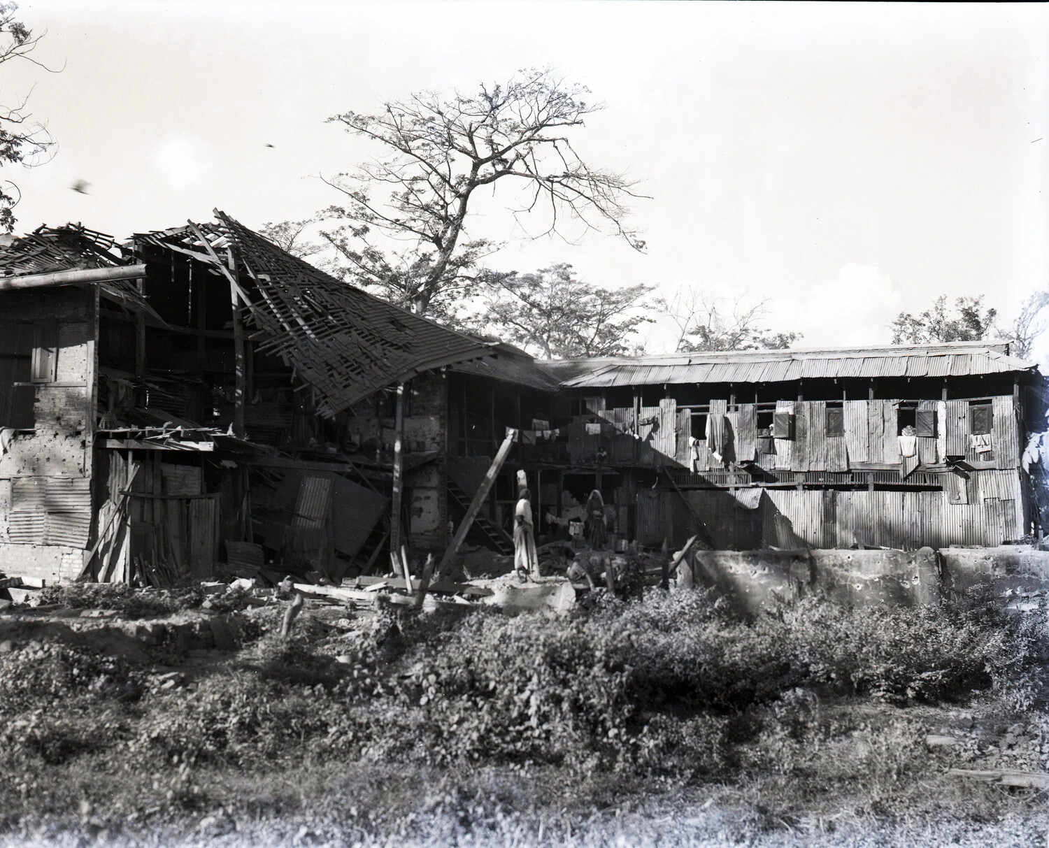 War-Damaged Corrugated Tin Buildings with Local Residents, CBI Theater, WWII