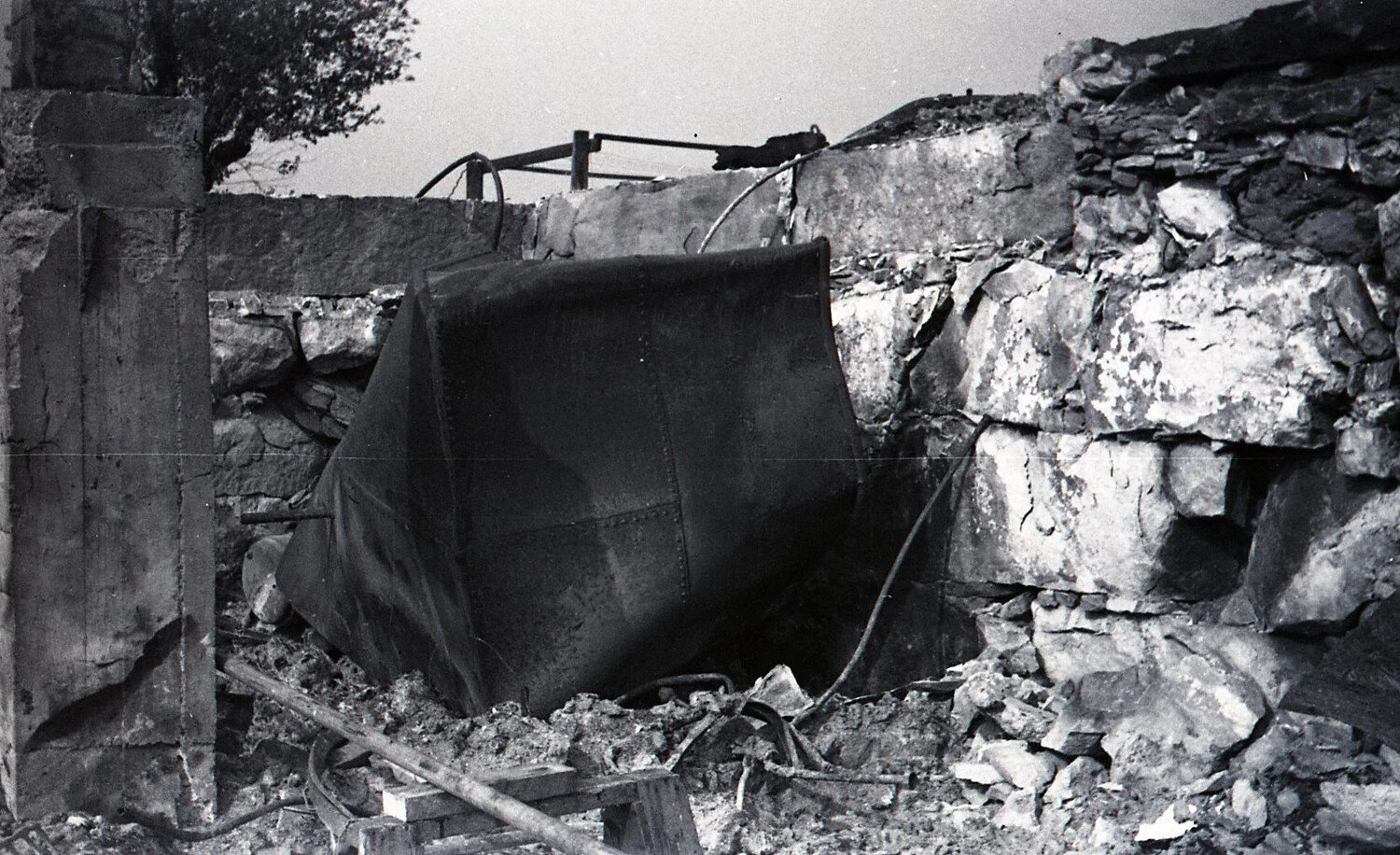 Sheet-Metal Tank Amid Demolished Stone Wall, American Dairy Farm