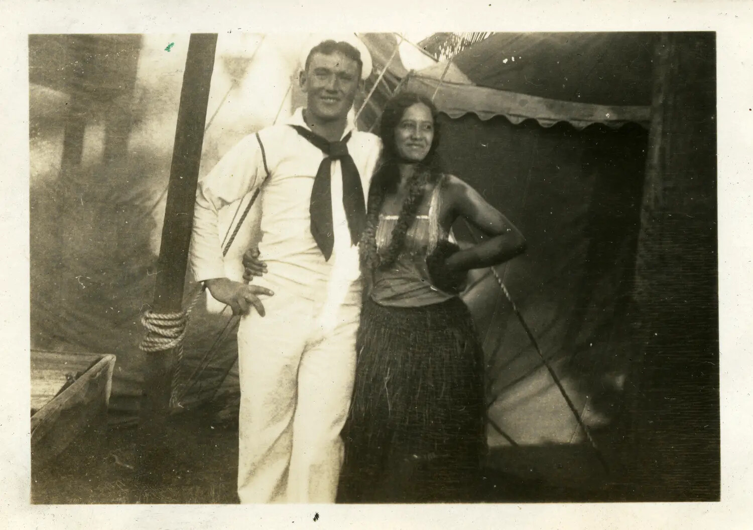 U.S. Navy Sailor Posing with Woman in Hawaiian Attire, USS Maryland Album, 1930s